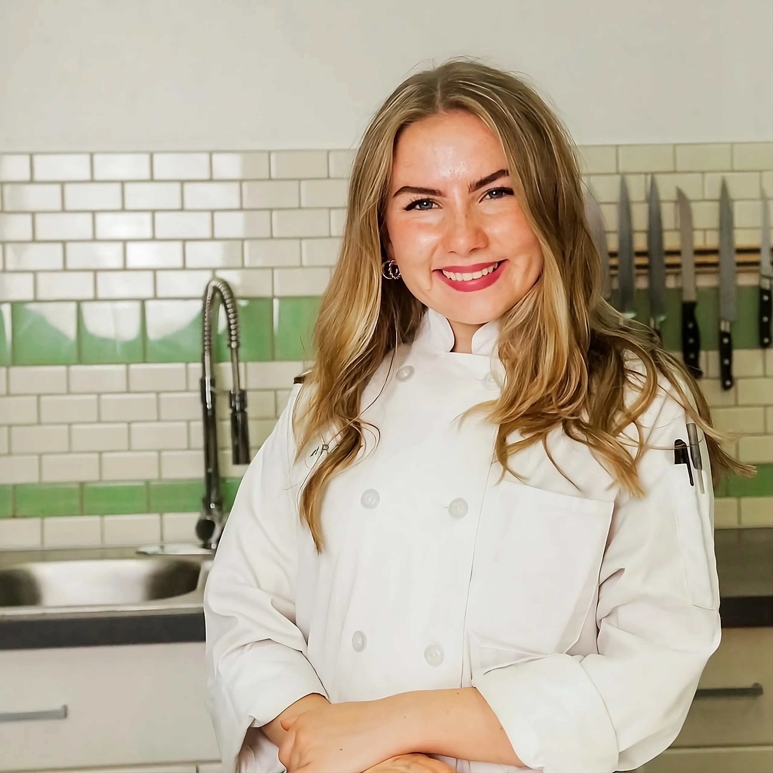 The Dairy-Free Dessert Expert Recipe Dish author Nora smiling in kitchen, specializing in Dairy-Free desserts.